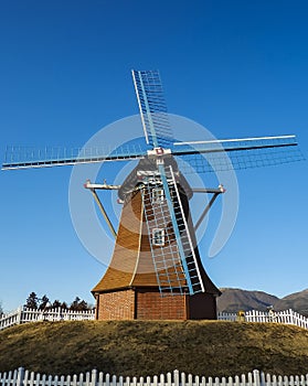 Windmill with background of blue sky and hills