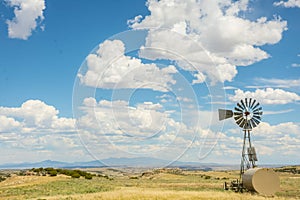 Windmill With Blue Cloudy Sky Mountain Landscape