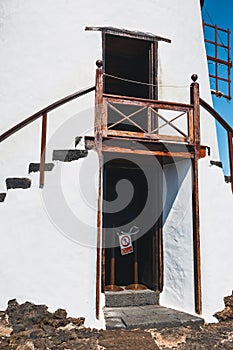 Windmill on blue sky background in cactus garden, Guatiza village, Lanzarote, Canary islands