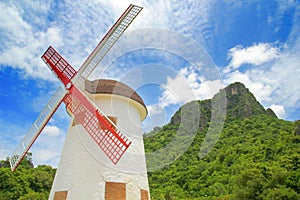 Windmill with blue sky and nature green mountain background