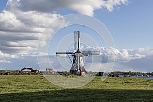 Windmill by the canal at Glimmen in Holland