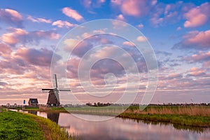 Windmill and Canal on Traditional Holland Landscape