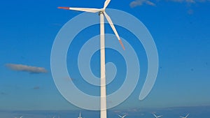Windmill closeup on blue sky and windmills set background.Green energy. Alternative energy sources.Environmentally