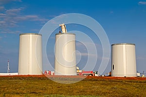 Windmill construction. Installation of wind turbine. Blue sky
