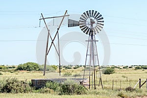 Windmill with dam and electricity pylon between Douglas and Prieska