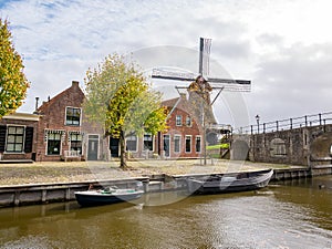 Windmill de Kaai, Heerenwal with houses and canal in Sloten, Sleat, Friesland, Netherlands photo