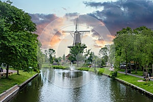 Windmill De Valk at sunset, tower mill and museum in Leiden city, Holland Netherlands