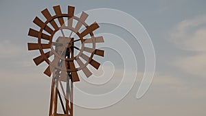 Windmill at desert in mist