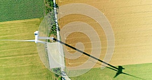 Windmill for electric power production in the agricultural fields. View from above. Slow motion