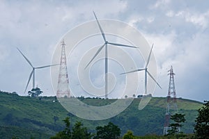 Windmill for electric power production with beautiful landscapes and blue skies to generate clean renewable green energy for