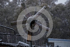 Windmill on farm covered in snow during winter