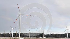 Windmill farm or wind park, with high wind turbines for generation electricity