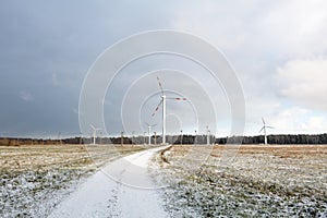 Windmill farm or wind park, with high wind turbines for generation electricity