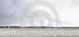 Windmill farm or wind park, with high wind turbines for generation electricity