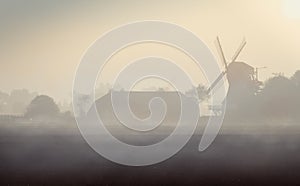 Windmill with farmhouse in the morning in northern Germany.