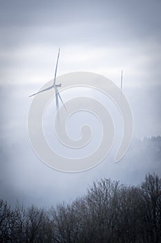 Windmill in a foggy forest