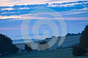 Windmill in foggy landscape. Renewable energy for environmentally conscious future