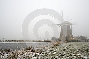 Windmill on a foggy winter morning