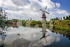 A windmill on the fortifications of the town of Woudrichem surrounded by the waters of two rivers.