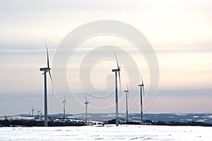 windmill generators, snow landscape. Powerplant electric turbine. Clean energy and eco energy concept.