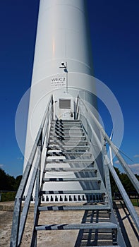 Windmill for green energy, wind turbine with blades that rotate on wind power and store in battery.