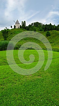 Windmill on a green hilltop