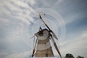 Windmill of Haastrecht along Hollandse IJssell with flags national Windmill day in the Netherlands