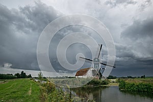 Windmill in Hazerswoude, Holland under stormy sky