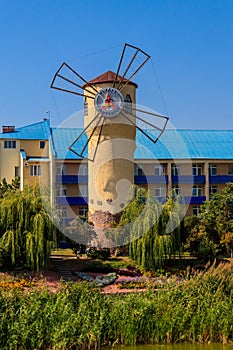 Windmill of Health on shore of Khorol river in wellness resort Myrhorod, Ukraine. Text translates as photo