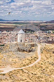 Windmill on the hill and in the background the village of Consuegra, Spain