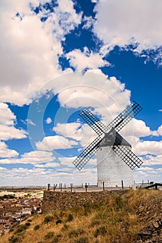 Windmill on the hill and in the background the village of Consuegra, Spain