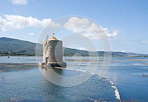 The windmill on the lagoon of Orbetello, Province of Grosseto, Italy, Europe.