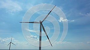 Windmill, large wind power turbines spinning to generating clean renewable energy for sustainable development