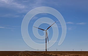 A windmill with modern wind turbines in the located in West Texas