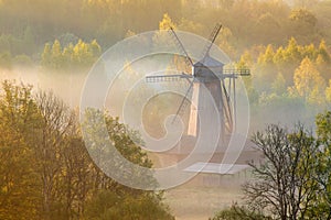 Windmill in the morning in fog