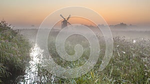 Windmill in morning meadow