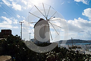 Windmill in Mykonos, Greece. Windmill on mountain landscape by sea. Whitewashed building with sail and straw roof with