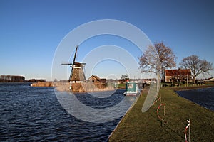 Windmill and old sluice at river Rotte in Zevenhuizen