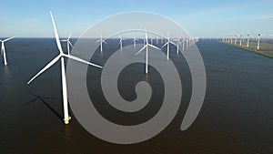 Windmill park in the ocean, drone aerial view of windmill turbines at sea in the Netherlands