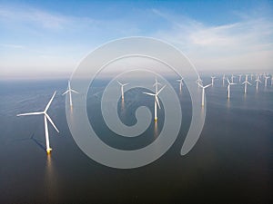 Windmill park westermeerdijk Netherlands, wind mill turbine with blue sky in ocean, green energy