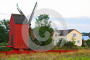 Windmill with red fence.