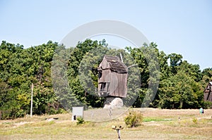 Windmill in a rural area. Wind Farm. Dutch windmill. Landscape with traditional Ukrainian windmills houses in countryside village