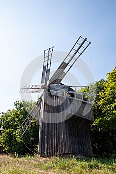 Windmill in a rural area. Wind Farm. Dutch windmill. Landscape with traditional Ukrainian windmills houses in countryside village