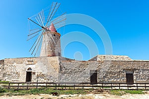 Windmill at the salt flats of Trapani, Sicily, Italy