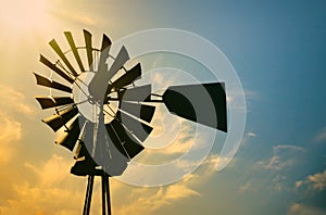 Windmill silhouette against morning sun in rural Texas