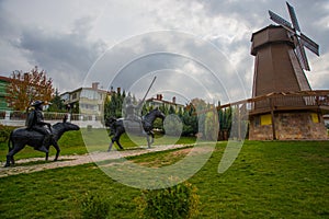 Windmill with sky as background. Sculpture of don Quixote and Sancho Panza. Selale Park, Eskisehir, Turkey