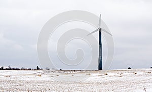 Windmill in snowy field
