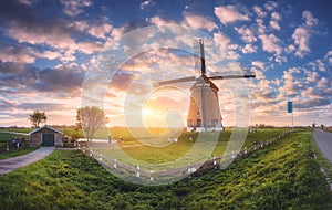 Windmill at sunrise in Netherlands. Spring panoramic landscape