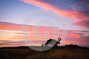 Windmill sunset at an Australian farm. The red sky