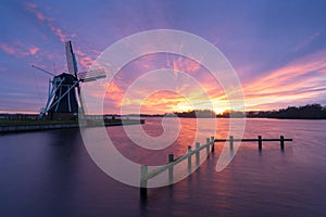 Windmill sunset at a lake